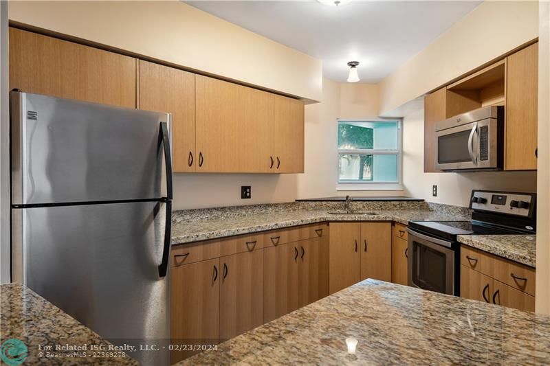 Updated kitchen with impact window and Whirlpool appliances.