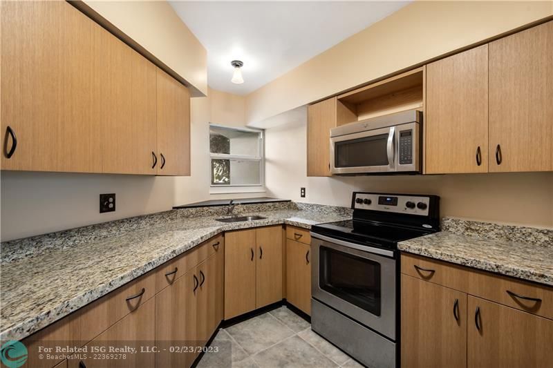 Updated kitchen with impact window and Whirlpool appliances.