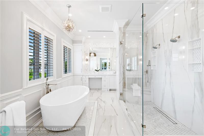 Primary bath with classic designed soaking tub, separate dual vanities, and dual shower!