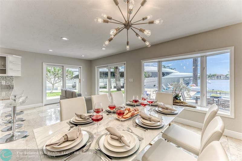 Dining Room Seating for 8 of Kitchen overlooking pool & waterway.