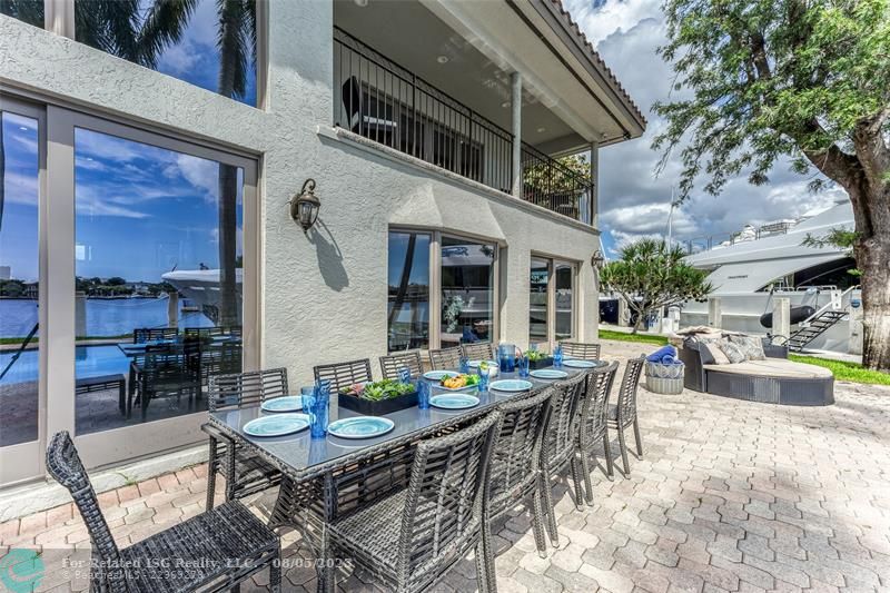 Outdoor waterfront Point Lot with pool area with outdoor dining, lounge chairs, BBQ & siting area.
