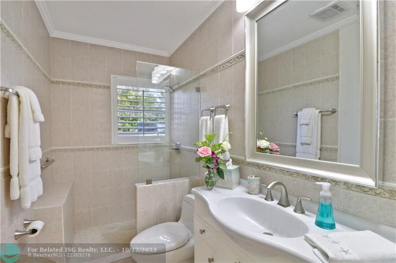 Bathroom shared by bedroom 1 & 2 with walk-in shower.