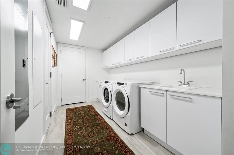 Huge laundry room laundry room with extensive cabinetry storage, closet & sink