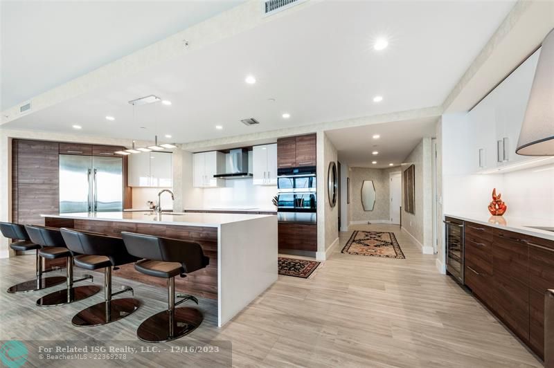 Gorgeous kitchen with Nolte cabinetry, tons of storage, large waterfall island, wet bar & amazing views!