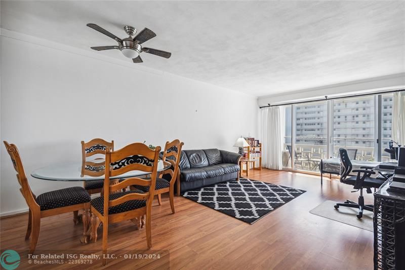 Open, bright living room with impact sliders (4 years old) and split AC (5 years old).