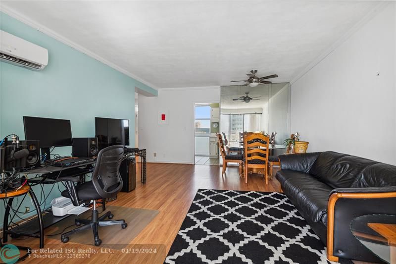 Open, bright living room with impact sliders (4 years old) and split AC (5 years old).