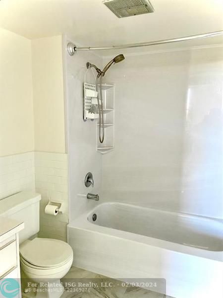 Primary bathroom with tub and shower combination