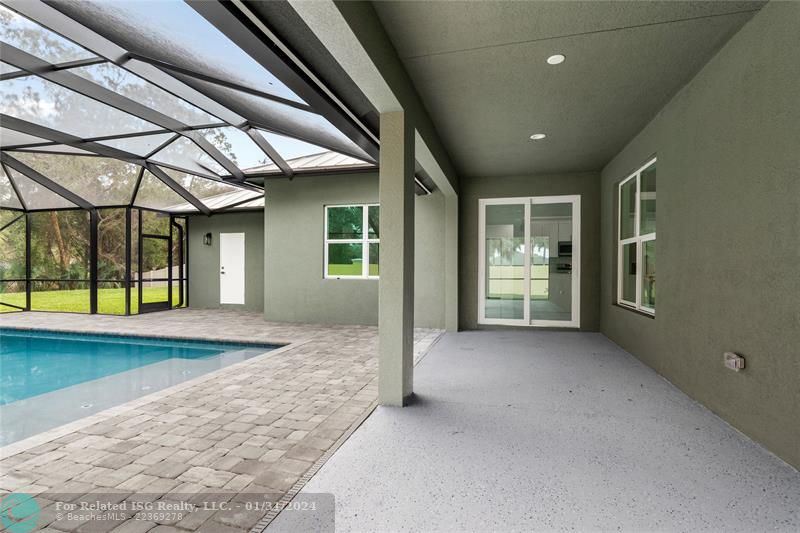 pool and covered patio.  White door to bathroom #3.