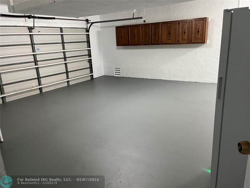 Garage showing cabinets