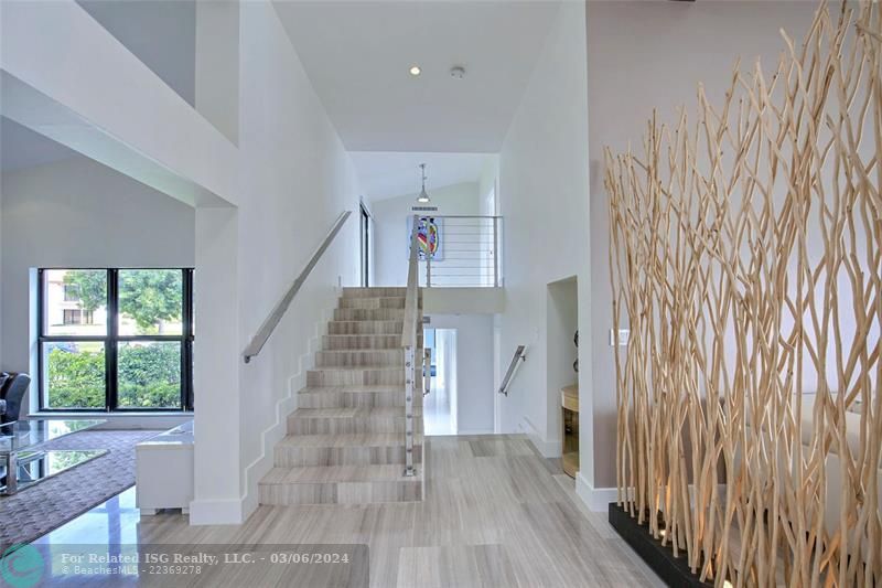 Stairway up to Primary Bedroom and down to 3 Guest Rooms