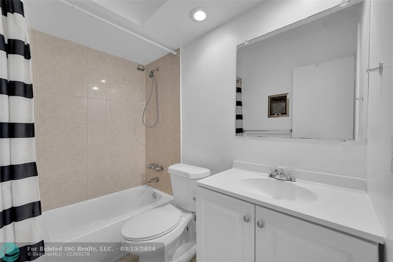 Guest bathroom with combination shower/tub