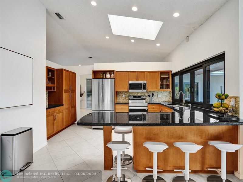 Open concept kitchen with high hat lighting