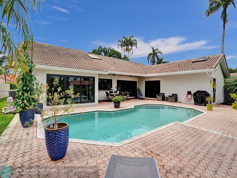 Invited pool area with paver patio and covered patio