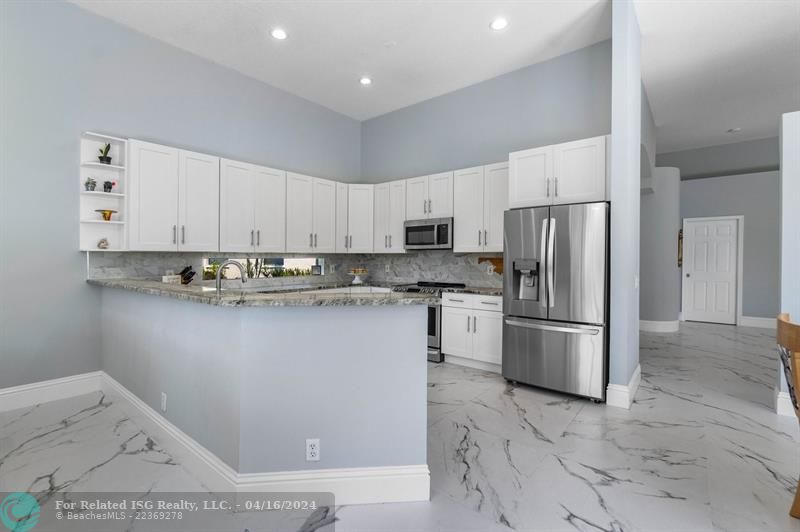 Chef's kitchen boasts stainless steel appliances, induction stove and convection oven.