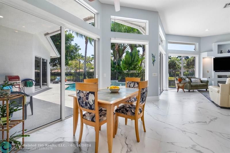 Dine in kitchen enables natural light and beautiful patio/pool and water views.