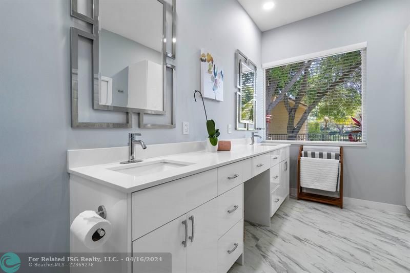 Double sinks and added storage create a useful and beautiful primary bathroom!