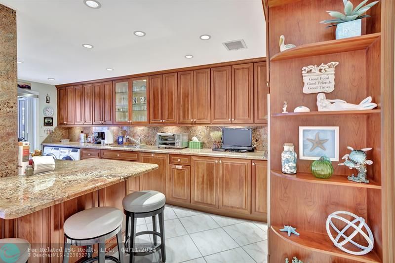 The Kitchen features Granite countertops with an eat-at bar, stainless steel appliances, ample storage space.