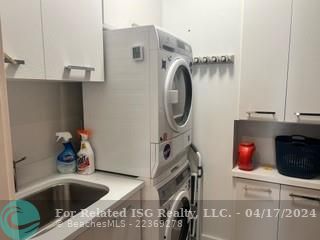 Laundry room next to half bath in condo