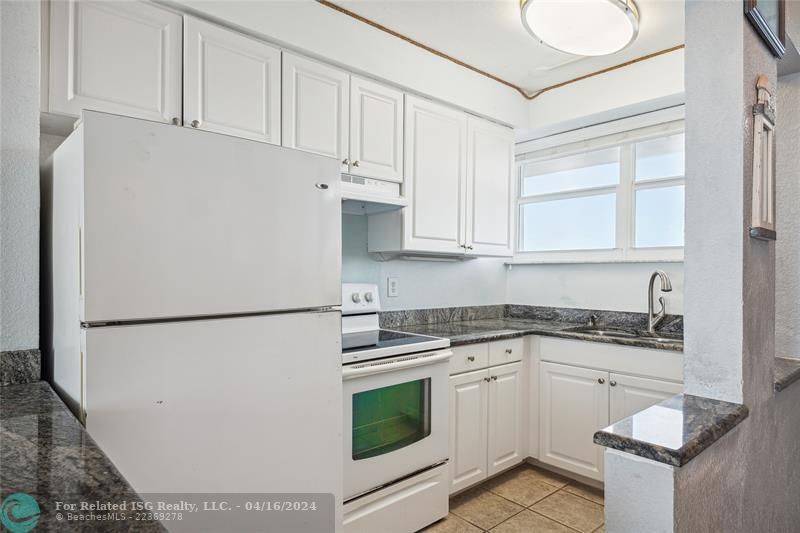 Bright kitchen that opens to your living room with a brand new range hood and oven that has never been used.