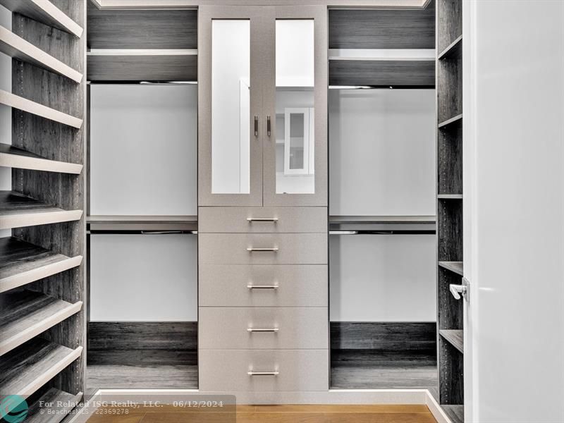 Large walk in pantry with refrigerated drawers and additional shelves on the left