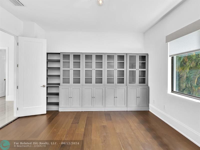 Large walk in pantry with refrigerated drawers and additional shelves on the left