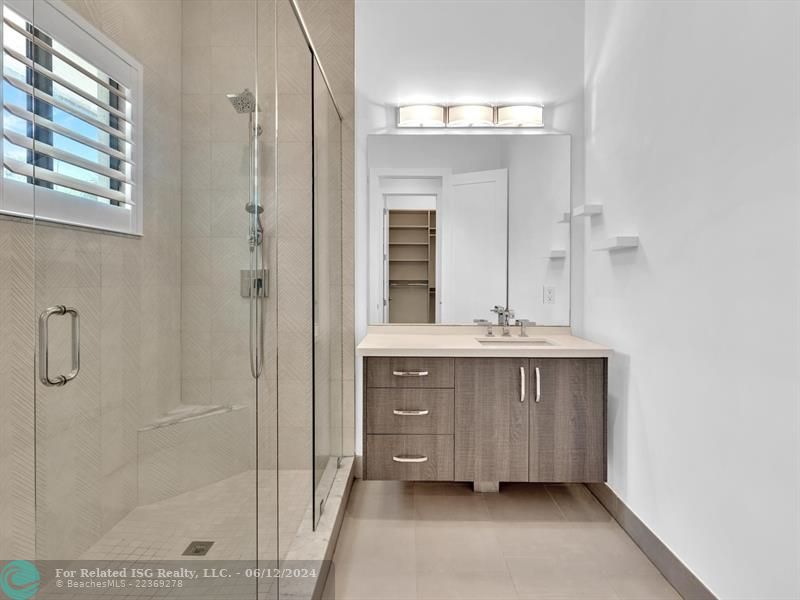 Large walk in pantry with refrigerated drawers and additional shelves on the left