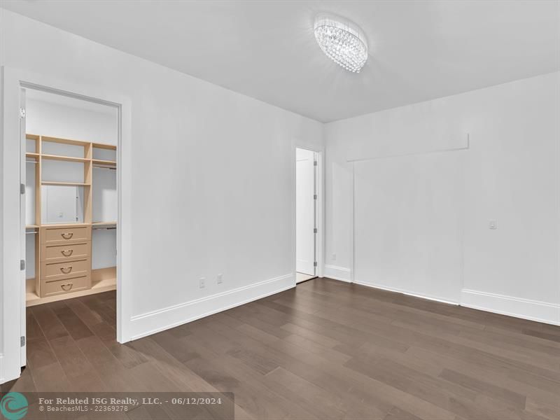 Large walk in pantry with refrigerated drawers and additional shelves on the left