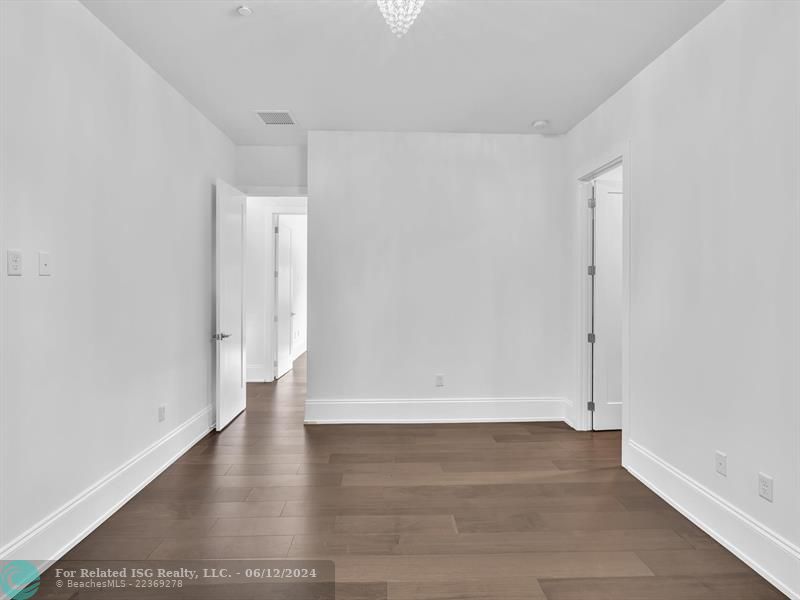 Large walk in pantry with refrigerated drawers and additional shelves on the left