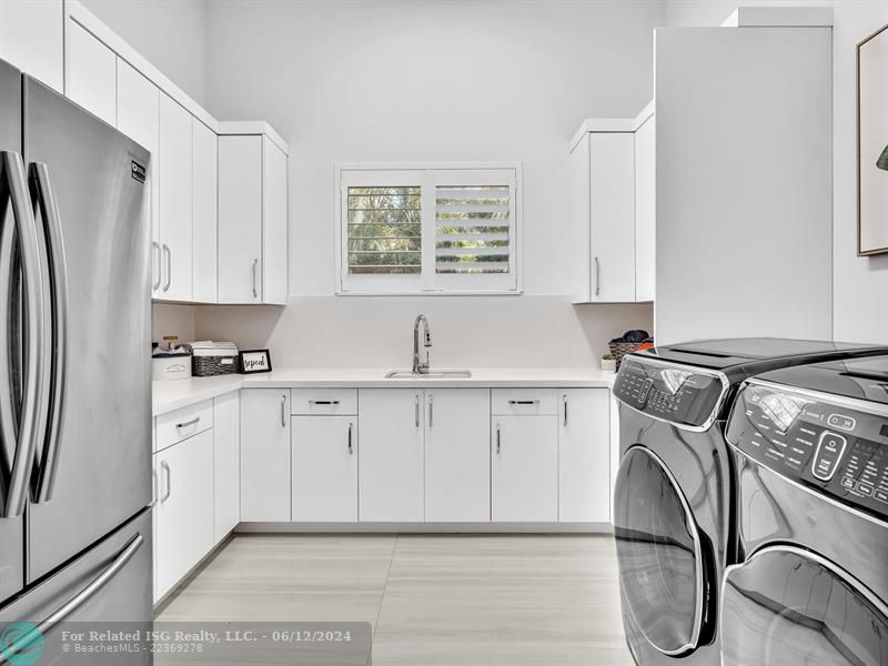 Large walk in pantry with refrigerated drawers and additional shelves on the left