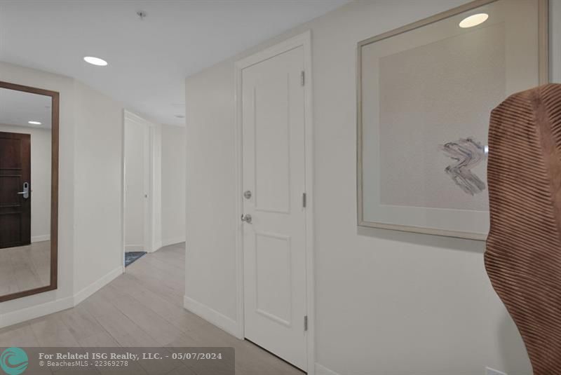 Entrance hall with owner's Closet on the right and open door to second full bathroom on the left.