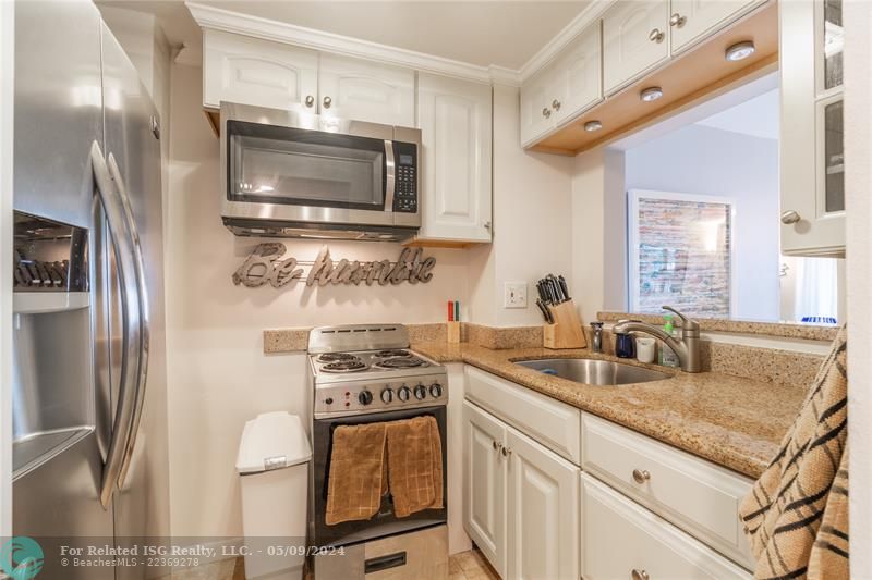 Kitchen area with new appliances.