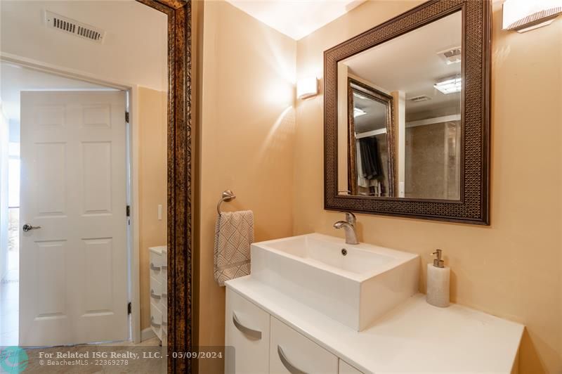 Nice sink and counter, with mirror that will stay.