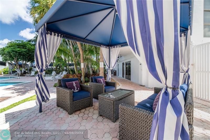 Covered patio area with comfortable seating