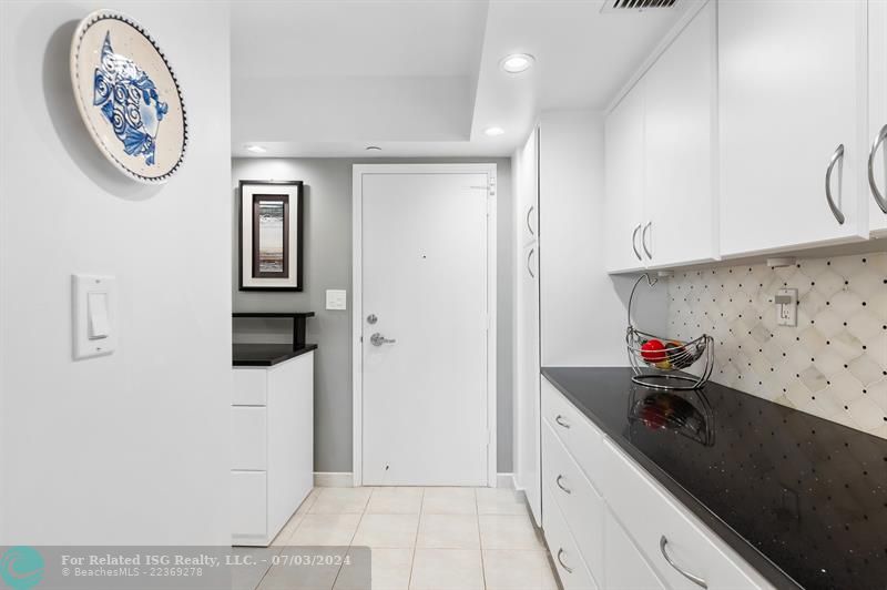 Kitchen entrance with wall of cabinetry