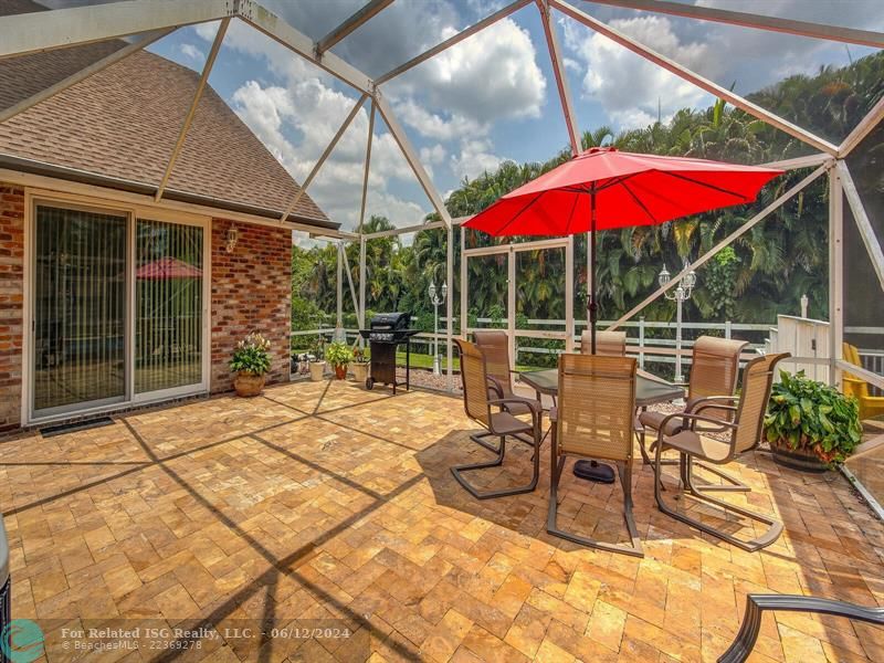 Travertine patio with lush landscaping