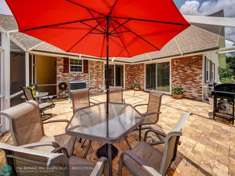 Travertine patio with lush landscaping