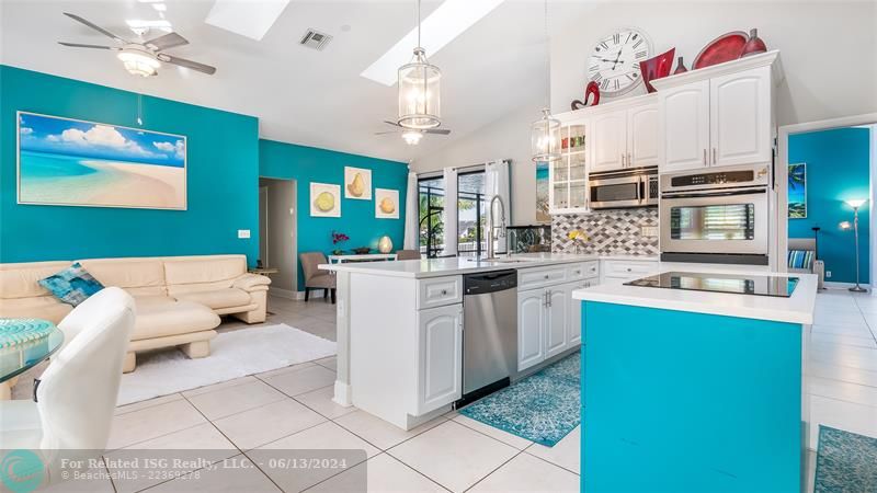 An entertainer's dream layout that cultivates togetherness - whip up culinary creations at the sprawling breakfast bar while socializing with loved ones. Enjoy natural light through skylights and the abundance of windows.