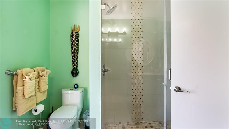 Notice the beauty of the seamless glass shower.