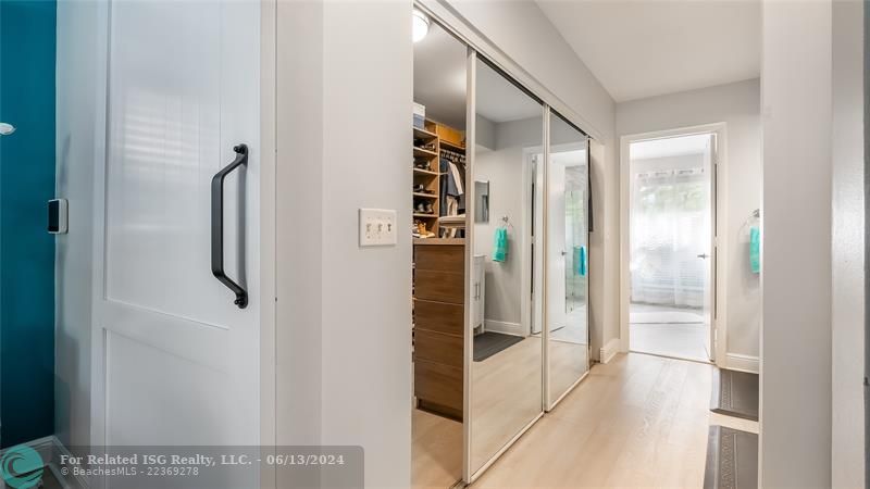 Just steps away, the exceptional custom-fitted walk-in closet showcases built-in shelving, drawers, and hanging rods to accommodate even the most extensive wardrobe and accessories