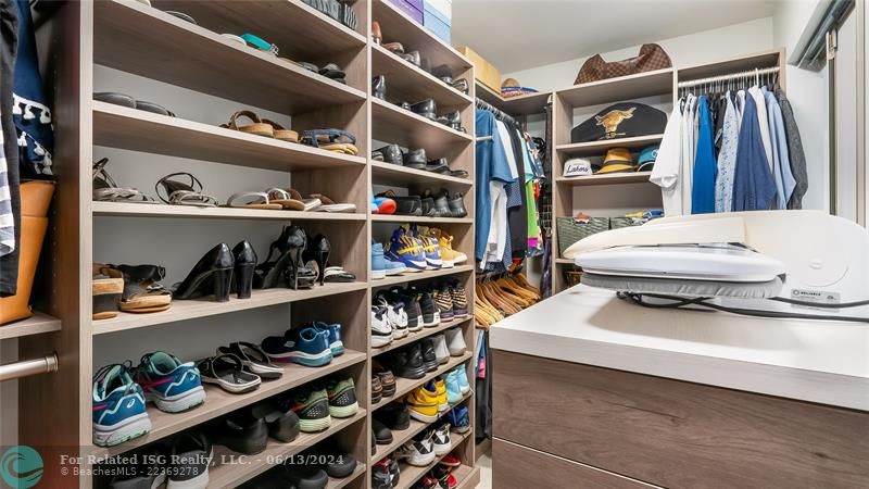 fitted walk-in closet showcases built-in shelving, drawers, and hanging rods to accommodate even the most extensive wardrobe and accessories