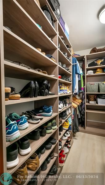 fitted walk-in closet showcases built-in shelving, drawers, and hanging rods to accommodate even the most extensive wardrobe and accessories