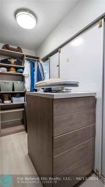 fitted walk-in closet showcases built-in shelving, drawers, and hanging rods to accommodate even the most extensive wardrobe and accessories