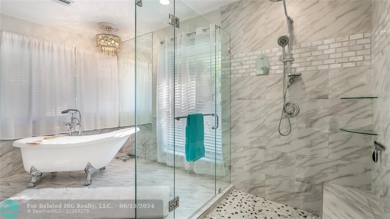 Soak away stress in the freestanding soaker tub positioned by a private view window.