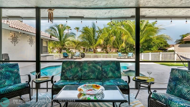 The covered patio truly recaptures the essence of cherished Florida living - embracing indoor/outdoor harmony against a private, scenic backdrop.