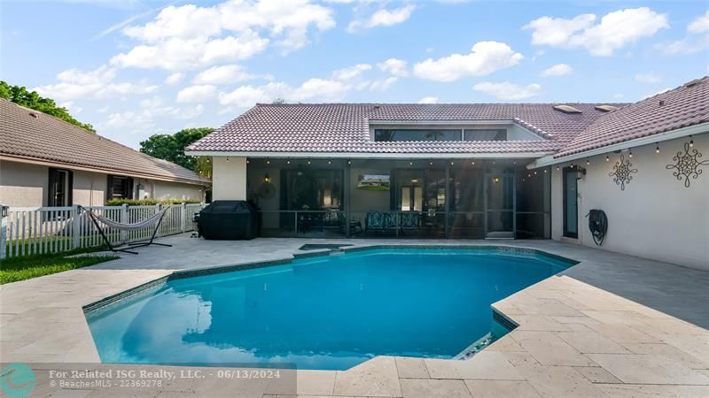 Ample deck space surrounds the pool, offering plenty of room for lounging and alfresco dining.