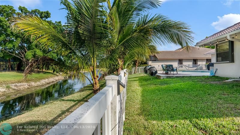 The well-maintained lawn and mature landscape is equipped with an automatic sprinkler system, ensuring the greenery stays vibrant year-round. Enjoy the coconuts and mangoes!