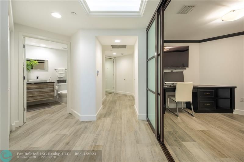 Entry foyer, guest bath and laundry to the left, den to the right