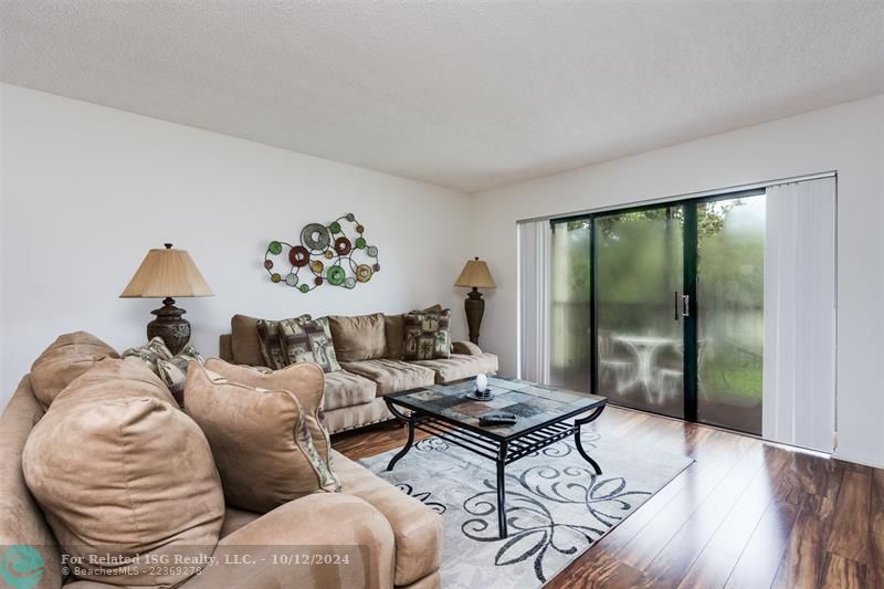 Living area with slider to screened in balcony