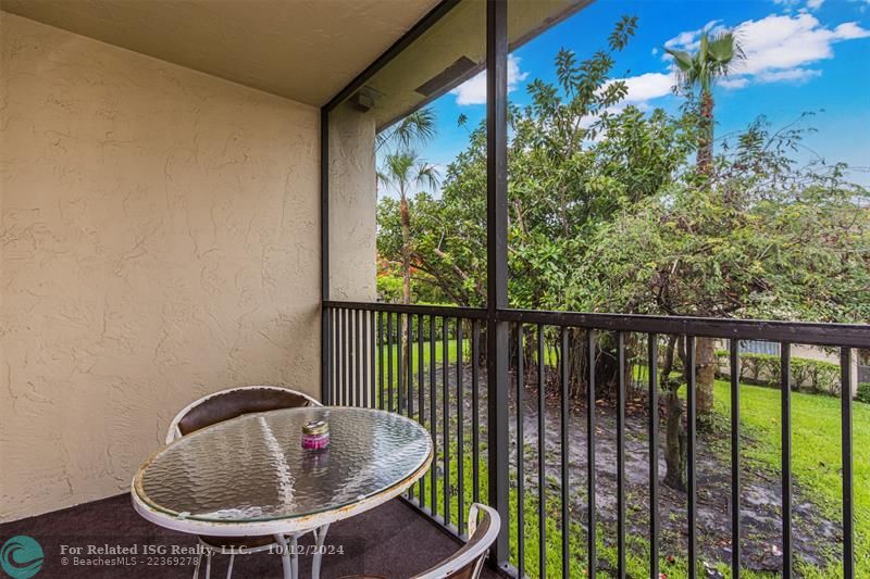 Screened in balcony overlooking garden area