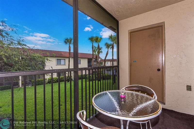 Screened in balcony overlooking garden area - extra storage closet